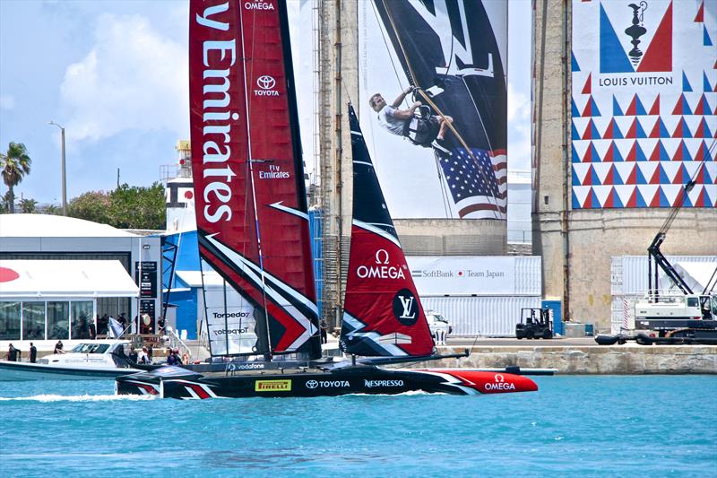 America's Cup champion, Emirates Team New Zealand eases away past the Japanese and US bases in Bermuda's Royal Dockyard photo copyright Richard Gladwell taken at Royal Bermuda Yacht Club and featuring the AC50 class