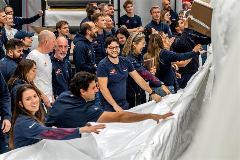 Team members unwrap AC75 Boat One as she arrives at Alinghi Red Bull Racing base in Barcelona, Spain, - March 4, 2024 photo copyright Olaf Pignataro/Red Bull Content Pool taken at Société Nautique de Genève and featuring the AC75 class