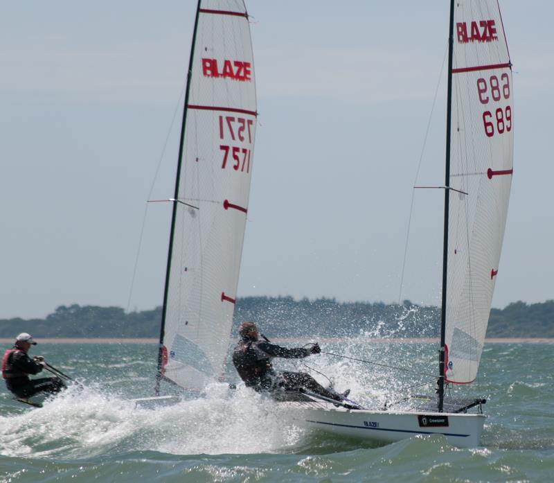 Pete Barton leading Myles Mence in Friday's race in the Blaze nationals at Warsash photo copyright Iain McLuckie taken at Warsash Sailing Club and featuring the Blaze class