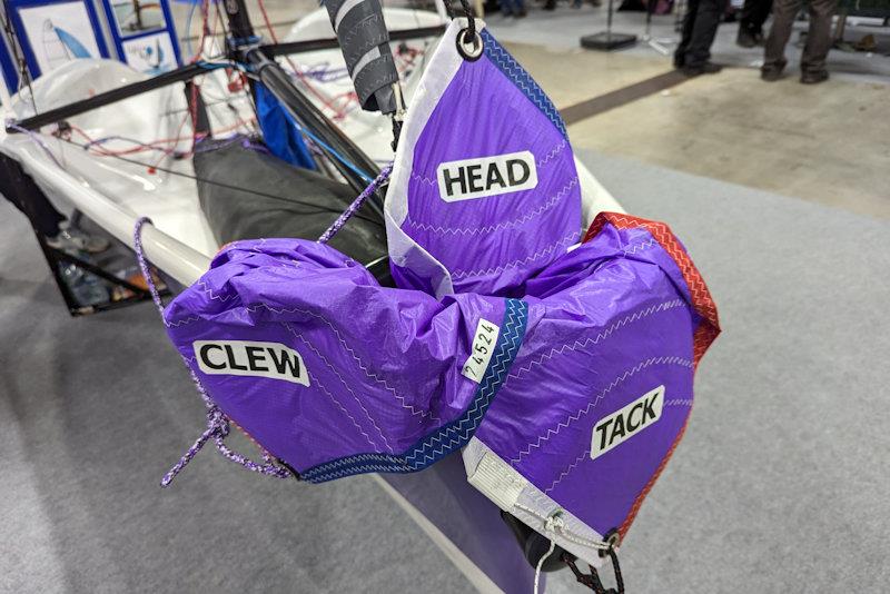 Purple patch at the RYA Dinghy & Watersports Show 2024 - spinnaker matching the hull on a Boss dinghy photo copyright Mark Jardine taken at RYA Dinghy Show and featuring the Buzz class
