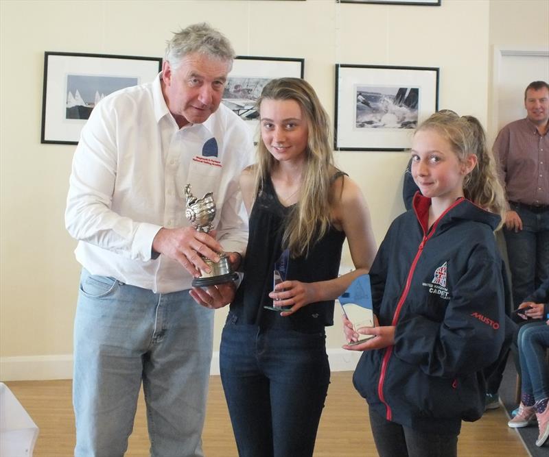 Lainey and Cally Terkelsen recieve the trophy from WPNSA Chief Peter Allam after the Zhik Cadet Clemenson Nautilus Trophy photo copyright Peter Collyer taken at Weymouth & Portland Sailing Academy and featuring the Cadet class