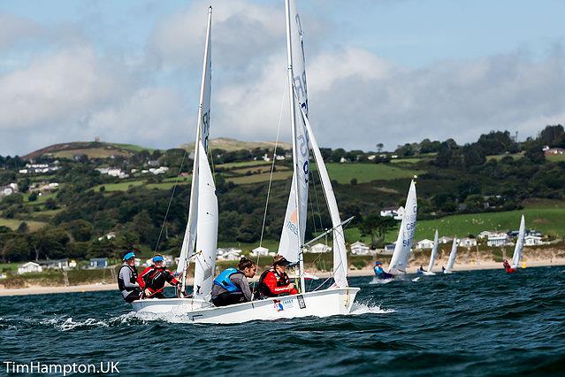 2017 Cadet National Champions Bettine Harris and Sam Goult leading from Megan Fergusson and Ollie Mears photo copyright Tim Hampton taken at South Caernarvonshire Yacht Club and featuring the Cadet class
