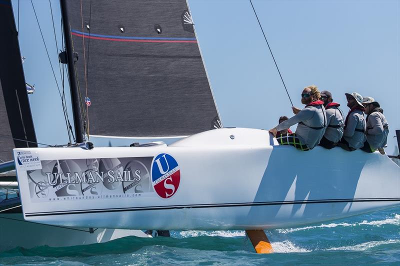 Ullman Sails crew in full flight on day 3 of Airlie Beach Race Week 2017 photo copyright Andrea Francolin taken at Whitsunday Sailing Club and featuring the Catamaran class