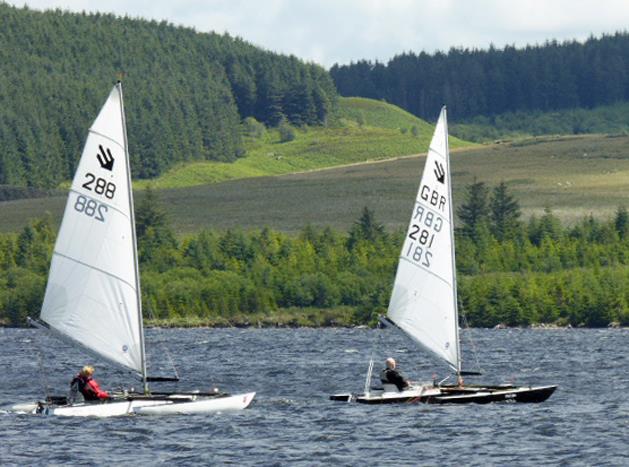 Diana Faulks chases Jack Alderdice during the Challenger Welsh Championship photo copyright Sue Hoare taken at Llyn Brenig Sailing Club and featuring the Challenger class