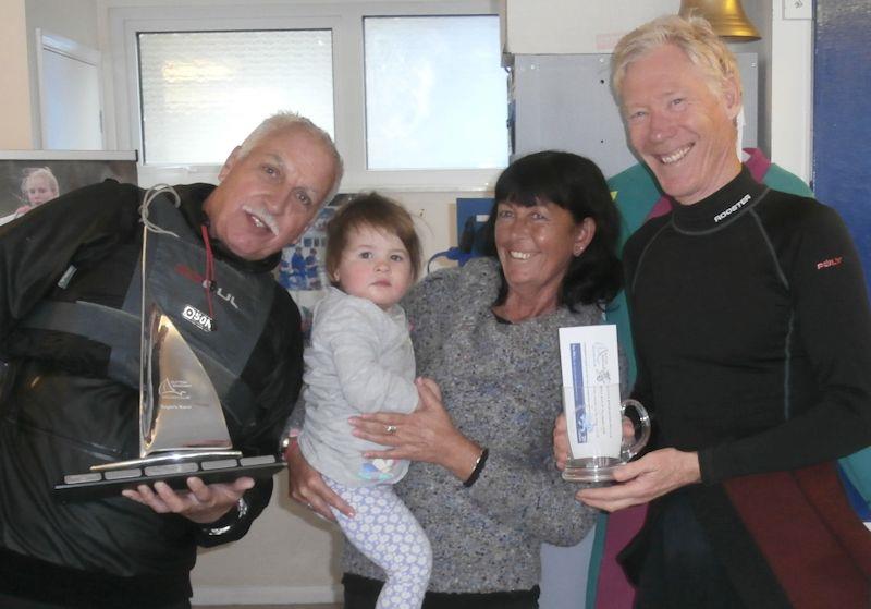 Howard Freer receives Roger's Race Trophy from Phil Bailey, club Commodore, and representatives of Roger's family - photo © Chris Jones