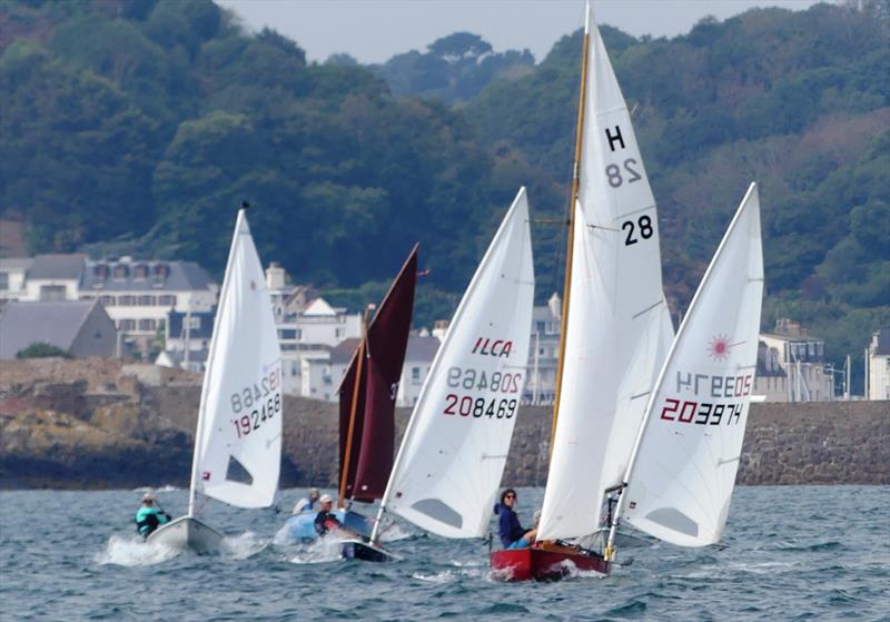 Dayboat and dinghy mix on Saturday during the Carey Olsen Jersey Regatta 2022 photo copyright Bill Harris taken at Royal Channel Islands Yacht Club and featuring the Dinghy class