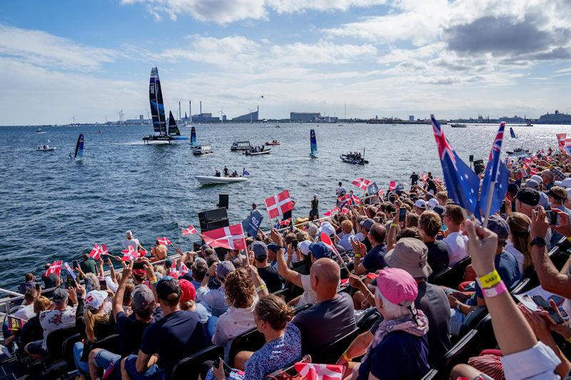 Spectators wave national flags from the Race Village while the New Zealand SailGP Team helmed by Peter Burling passes by on Race Day 2 of the ROCKWOOL Denmark Sail Grand Prix in Copenhagen, Denmark photo copyright Jon Super for SailGP taken at  and featuring the F50 class