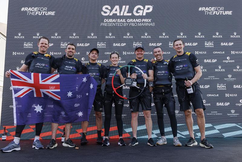 The Australia SailGP Team pose with the trophy and a Australian flag on the stage after winning the Dubai Sail Grand Prix presented by P&O Marinas in Dubai, United Arab Emirates. 13th November photo copyright Felix Diemer for SailGP taken at Dubai Offshore Sailing Club and featuring the F50 class