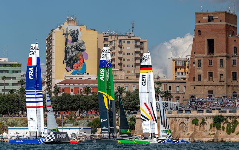 France SailGP Team, Australia SailGP Team and Germany SailGP Team sail past the SailGP Race Stadium, Palazzo del Governo and a Mural of their God of the Sea on Race Day 2 of the ROCKWOOL Italy Sail Grand Prix in Taranto, Italy photo copyright Ricardo Pinto for SailGP taken at  and featuring the F50 class