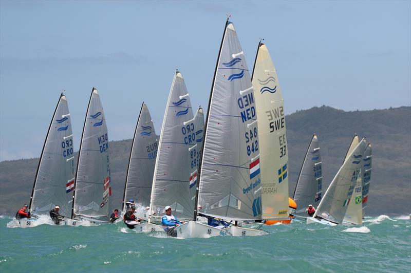 Postma leads downwind on day 4 of the Finn Gold Cup in New Zealand photo copyright Robert Deaves taken at Takapuna Boating Club and featuring the Finn class