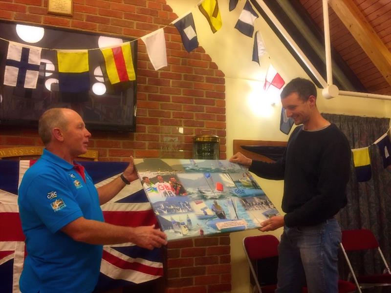 John Heyes presents Giles Scott with the photomontage canvas of his victory in Rio - photo © BFA