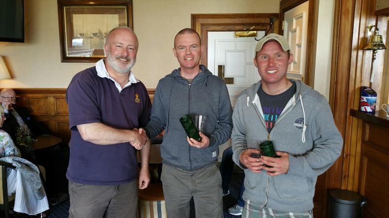 The Clancy brothers (2nd) with event director Fenton Parsons at the Fireball Ulster Championship photo copyright Frank Miller taken at Royal North of Ireland Yacht Club and featuring the Fireball class