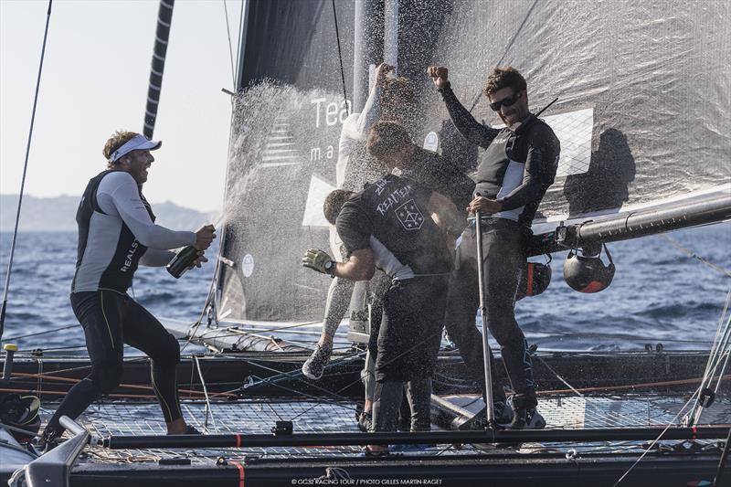Celebrations begin onboard Realteam at Marseille One Design photo copyright Gilles Martin-Rager / GC32 Racing Tour taken at  and featuring the GC32 class