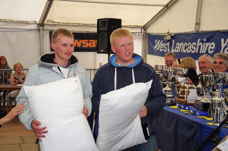 24 hour fundraisers Sam (left) and Ed (right) being presented with a pillow each after the Crewsaver West Lancs 24 Hour Race photo copyright Richard Craig / www.SailPics.co.uk taken at West Lancashire Yacht Club and featuring the GP14 class