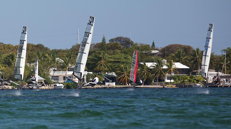 The  US International Moth Championships fleet screams downwind toward the beach in one of half a dozen impromptu races after official racing was cancelled on Sunday in front of the Upper Keys Sailing Club - photo © Meredith Block / US Moth Class