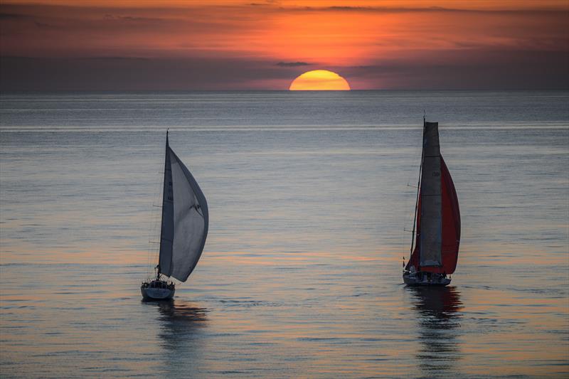 LIBERA (ITA) and EOS (GBR) sailing towards the sunset in the Rolex Middle Sea Race photo copyright Kurt Arrigo / Rolex taken at Royal Malta Yacht Club and featuring the IRC class