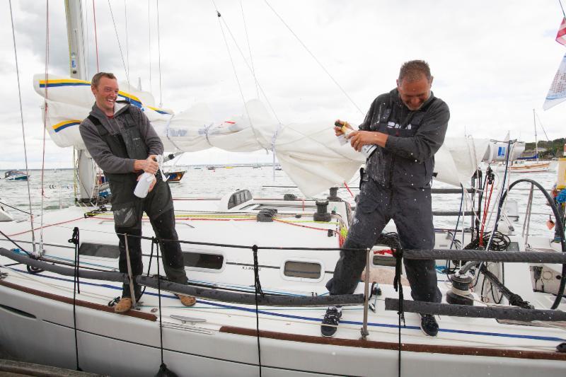 Lula Belle, Irish Two-Handed team, Liam Coyne and Brian Flahive spray their celebratory champagne after finishing the Sevenstar Round Britain and Ireland Race photo copyright Patrick Eden / RORC taken at Royal Ocean Racing Club and featuring the IRC class