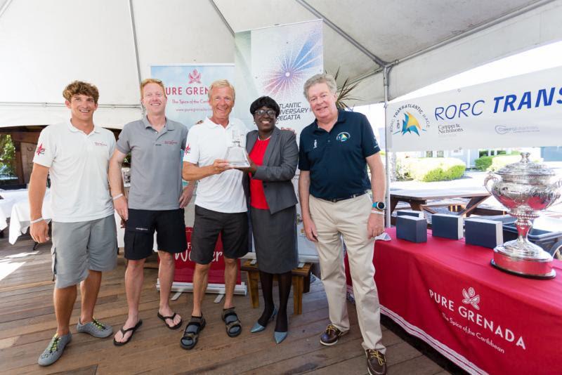Tilmar Hansen and his crew of Outsider receive their trophy from Minister for Tourism, Civil Aviation and Culture, Hon Dr Clarice Modeste-Curwen and RORC Admiral Andrew Mcirvine - photo © RORC / Arthur Daniel