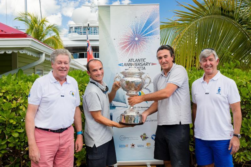 Andrew McIrvine, RORC Admiral and Eddie Warden Owen, RORC CEO present crew of Eric de Turckheim's French Teasing Machine with the RORC Transatlantic Race Trophy photo copyright RORC / Arthur Daniel taken at  and featuring the IRC class