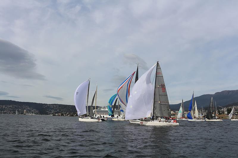 The Bruny Island race fleet passed a large cruise ship berthed in Hobart - photo © Penny Conacher