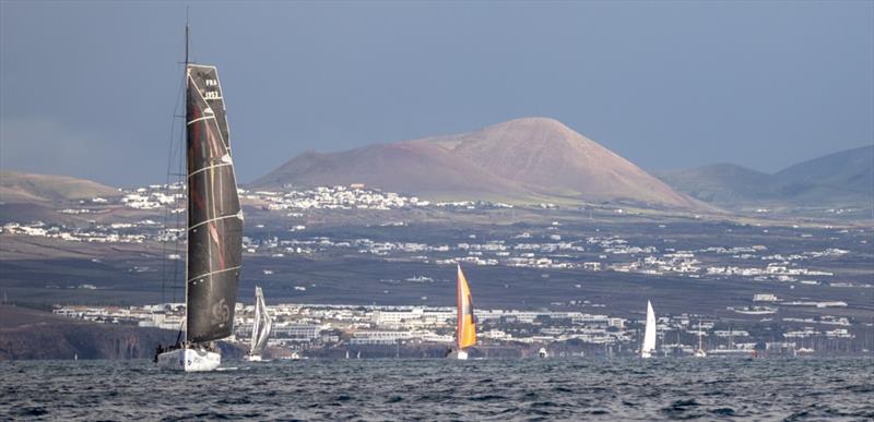 The dramatic volcanic mountains of Lanzarote make an impressive backdrop as the RORC Transatlantic Race fleet head for Grenada - photo © James Mitchell