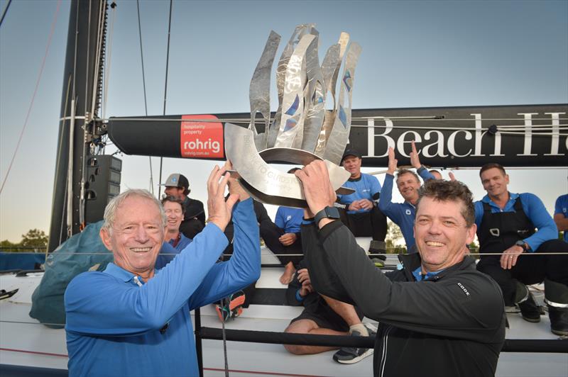 Peter Harburg, Mark Bradford and the Black Jack crew celebrate winning line honours and smashing their race record in the 74th Brisbane to Gladstone Yacht Race photo copyright Andra Bite taken at Queensland Cruising Yacht Club and featuring the IRC class