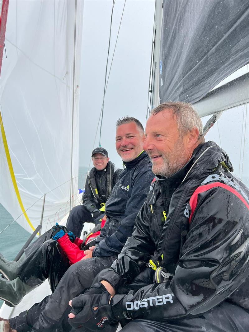 Wet crew on Mojito as the heavens opened - photo © Peter Dunlop