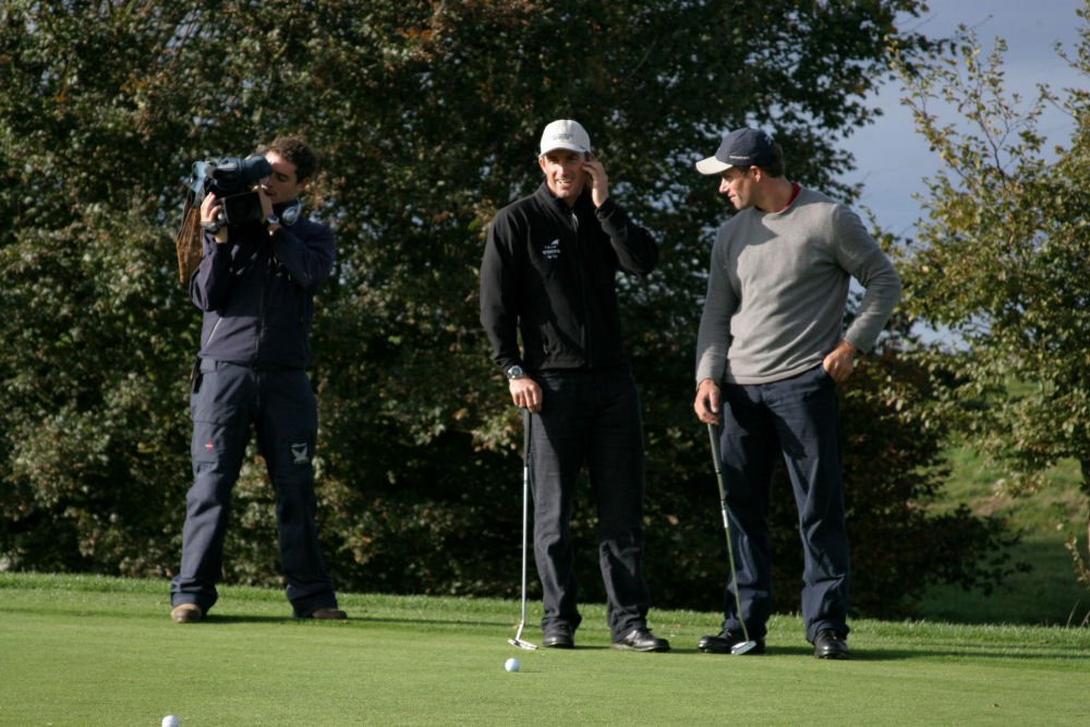 Olympic Medallists Ben Ainslie and Iain Percy being filmed on the course during the ninth North Sails Golf Day for the John Merricks Sailing Trust photo copyright Ian Finlay / www.ianfinlay.com taken at  and featuring the JMST class
