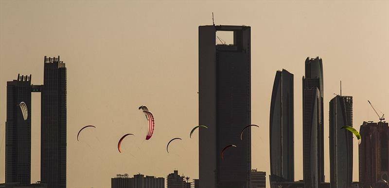 Kites fly amongst the towers on day 1 of the ISAF Sailing World Cup Final in Abu Dhabi photo copyright Pedro Martinez / Sailing Energy / ISAF taken at  and featuring the Kiteboarding class