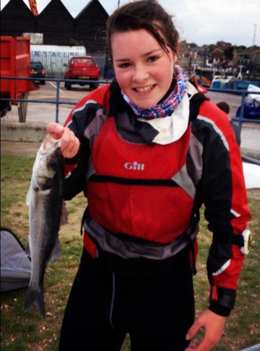 Clementine Thompson with the sea bass that landed in her boat photo copyright David Thompson taken at Whitstable Yacht Club and featuring the ILCA 6 class