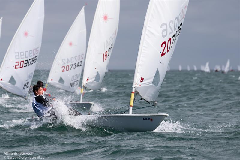 Lourenco Mateus on day 4 of the KBC Laser Radial World Championships in Ireland photo copyright Gareth Craig / www.fotosail.com taken at Royal St George Yacht Club and featuring the ILCA 6 class