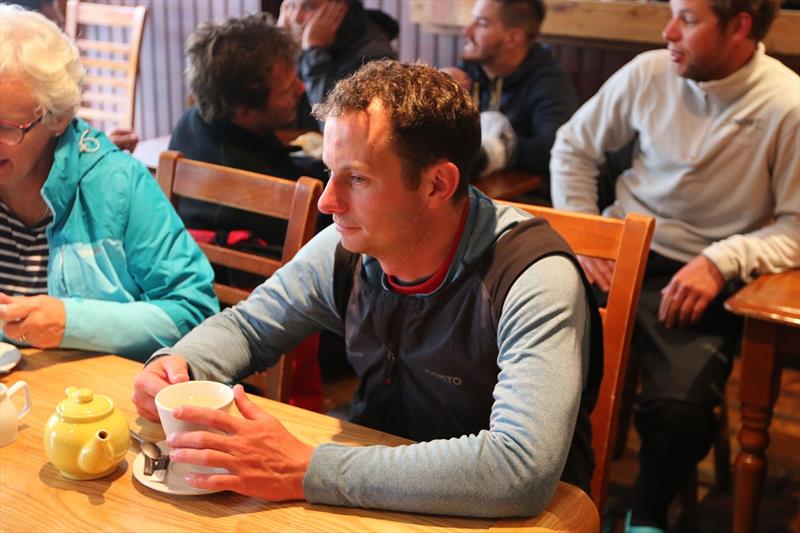 Nick Cherry waits for his much anticipated burger in the famous Piew View pub as the La Solitaire Bompard Le Figaro fleet arrives in Cowes photo copyright Artemis Offshore Academy taken at  and featuring the Figaro class
