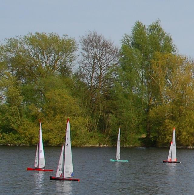 2024 Mermaid Trophy GAMES 4 at Guildford: Oliver's red F6 leads Rob's UP (41), Barrie's STARKERS (103) & Lewis' STARKERS (77) downwind to the gate photo copyright Celia Greetham taken at Guildford Model Yacht Club and featuring the Marblehead class
