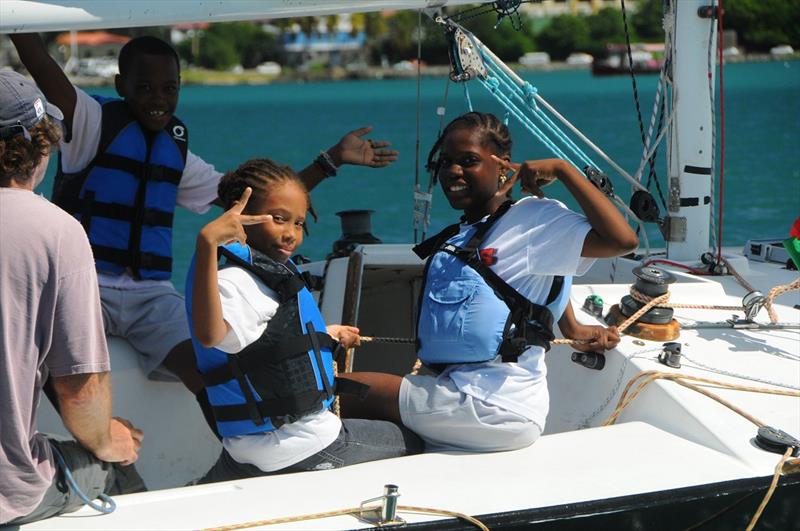 Students from the Gladys Abraham Elementary School on St. Thomas participate in the 2013 Carlos Aguilar Match Race Youth Regatta, with USA Skipper, Dave Perry (far left) photo copyright Dean Barnes taken at St. Thomas Yacht Club and featuring the Match Racing class
