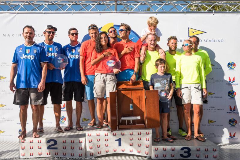Melges 20 Corinthian World Champion Emanuele Savoini and his Evinrude team celebrate winning the top-amateur trophy alongside second place Cesar Gomes Neto on Portobello (left) and Mirko Bartolini's Spirit of Nerina (right) photo copyright Barracuda Communication taken at Club Nautico Scarlino and featuring the Melges 20 class
