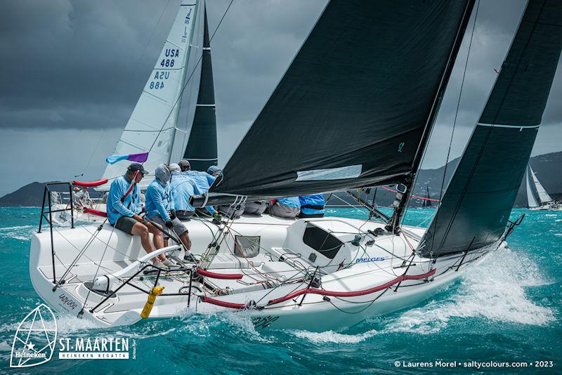 A dark sky consumed the fleet as they tacked through Marigot Bay, but all competitors held fast with full mains in over 20 kts of breeze - St. Maarten Heineken Regatta day 3 photo copyright Laurens Morel / www.saltycolours.com taken at Sint Maarten Yacht Club and featuring the Melges 32 class