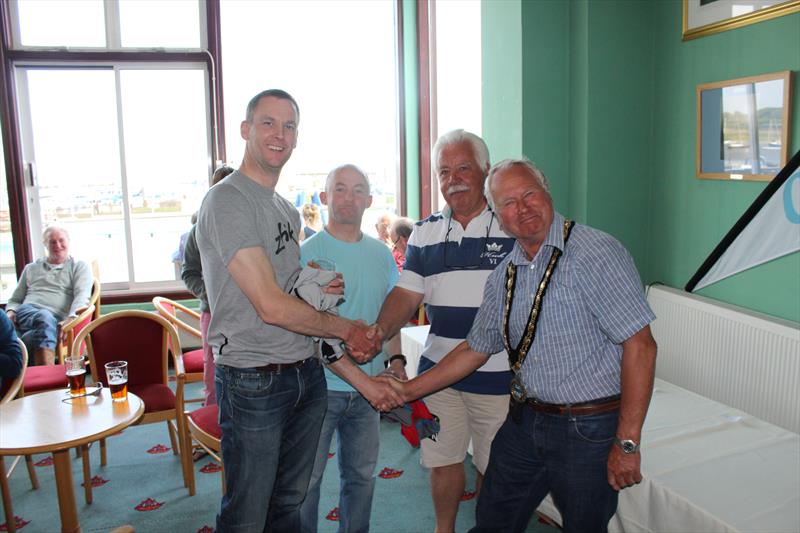Roger Gilbert and James Stewart win the Lymington Town Silver Tiller: congratulated by Rick Underhill (Commodore) and Barry Dunning (Mayor of Lymington) photo copyright Keith and Liam Willis taken at Lymington Town Sailing Club and featuring the Merlin Rocket class