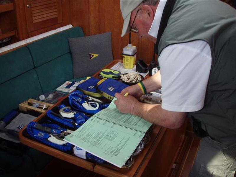 Bermuda Race Organizing Committee inspector John Winder reviews the safety equipment checklist photo copyright BROC taken at Cruising Club of America