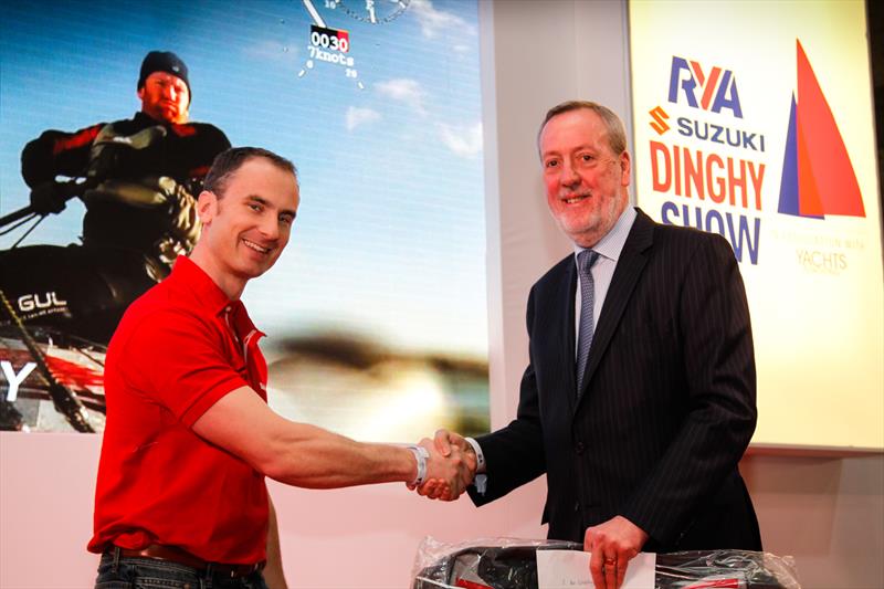Mike Pope, executive chairman of GJW Direct, presenting Ben Schooling his prize photo copyright Paul Wyeth / RYA taken at RYA Dinghy Show