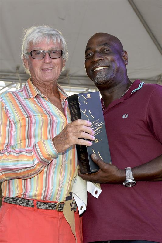 Two veteran sporting icons from Antigua: Sir Viv Richards presents Biwi Magic owner, Geoffrey Pidduck with Johnnie Walker prizes for first place  on day 2 of Antigua Sailing Week photo copyright Ted Martin / www.photofantastyantigua.com taken at Antigua Yacht Club