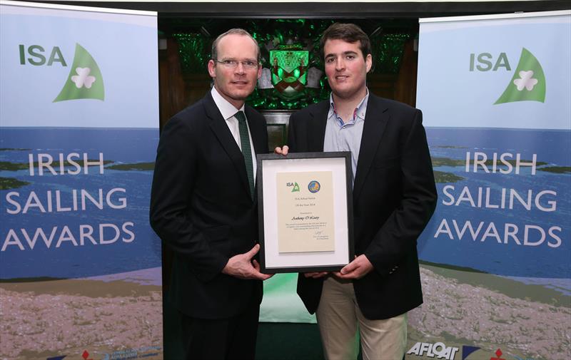 Simon Coveney TD, Minister for Agriculture, Food and the Marine, presents Rob O'Leary who is accepting the award on behalf of his father Anthony O'Leary of the Royal Cork Yacht Club for the ISA/Afloat Sailor of the Year - photo © INPHO / Cathal Noonan