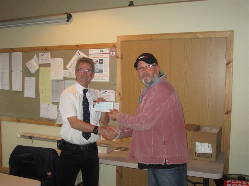 Jim Holland, Solway YC Commodore (right), presenting Gareth Jones, RNLI Kippford Operations Manager, with a cheque for £550 raised by competitors in the Solway YC Kippford RNLI Regatta photo copyright Ian Purkis taken at Solway Yacht Club