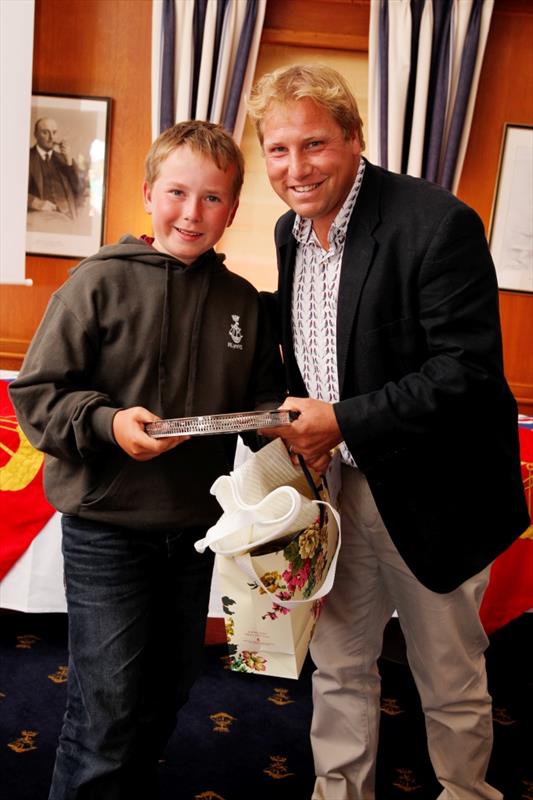 Charles Overton is presented with the Walhampton Trophy by Nigel Reed during the Royal Lymington YC Youth Week Prize giving photo copyright Jerzy Kanarek taken at Royal Lymington Yacht Club