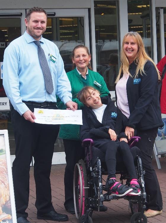 Morrisons Store Manager Andy Woodford and Community Champion Lyn Davis award a cheque to Natasha Lambert photo copyright Miss Isle taken at 