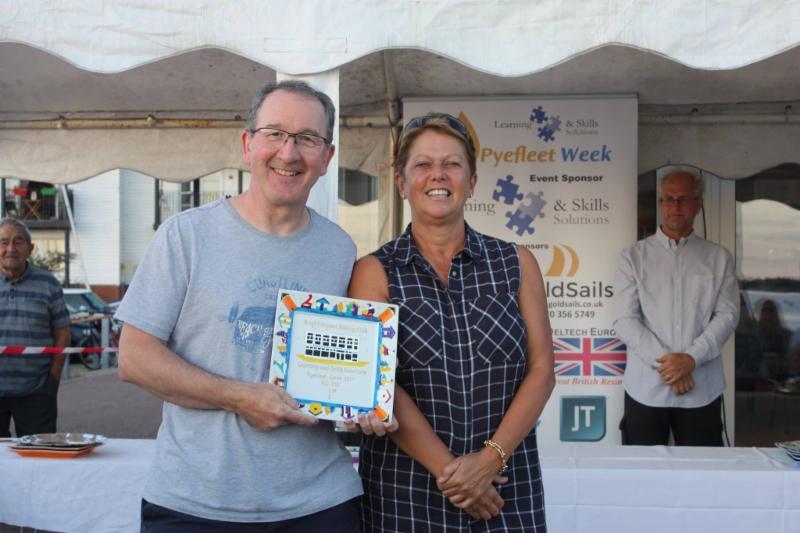 Pete Purkiss claims his RS700 prize from Sue Bouckley of Learning & Skills Solutions at Learning & Skills Solutions Pyefleet Week photo copyright Mandy Bines taken at Brightlingsea Sailing Club