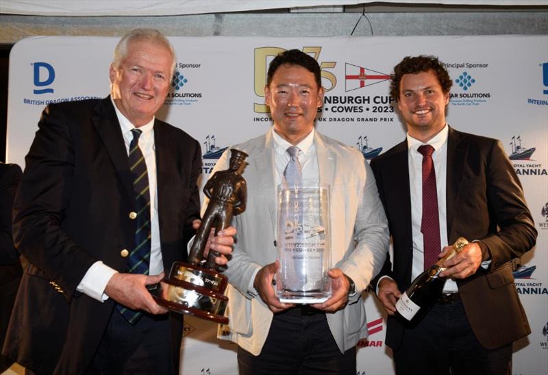L-R - Peter Gilmour, Yasuhiro Yaji and Sam Gilmour receive the new Britannia Trophy, for the boat with the best score without discard photo copyright Rick and James Tomlinson taken at Royal Yacht Squadron