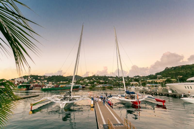 Side-by-side as the sun sets. The crew of Phaedo3 and Maserati compare their race on the dock at Camper & Nicholsons Port Louis Marina, Grenada after the finish of the RORC Transatlantic Race photo copyright RORC / Arthur Danie taken at  and featuring the MOD70 class