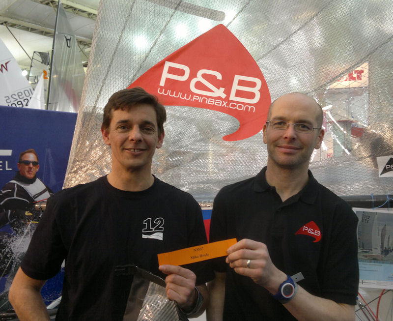 Tom Stewart pulls the lucky name out the hat for the P&B sponsored 'Early entry Burton Week Draw' at the RYA Dinghy Show photo copyright NTOA taken at RYA Dinghy Show and featuring the National 12 class
