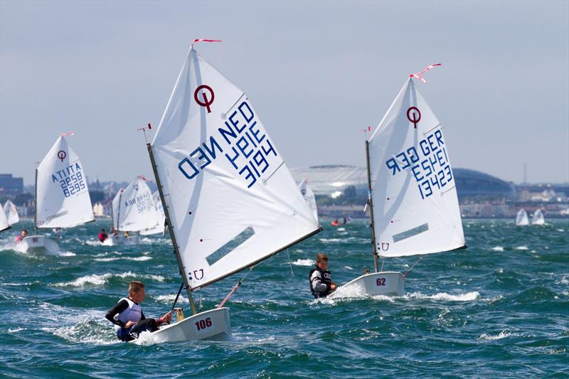  Scott Meijntjes (NED 3194) and Linus Klasen (GER 13423) lead the fleet past the Aviva Stadium in the second race of the Optimist European Championships on Dublin Bay photo copyright Gareth Craig / www.fotosail.com taken at Royal St George Yacht Club and featuring the Optimist class