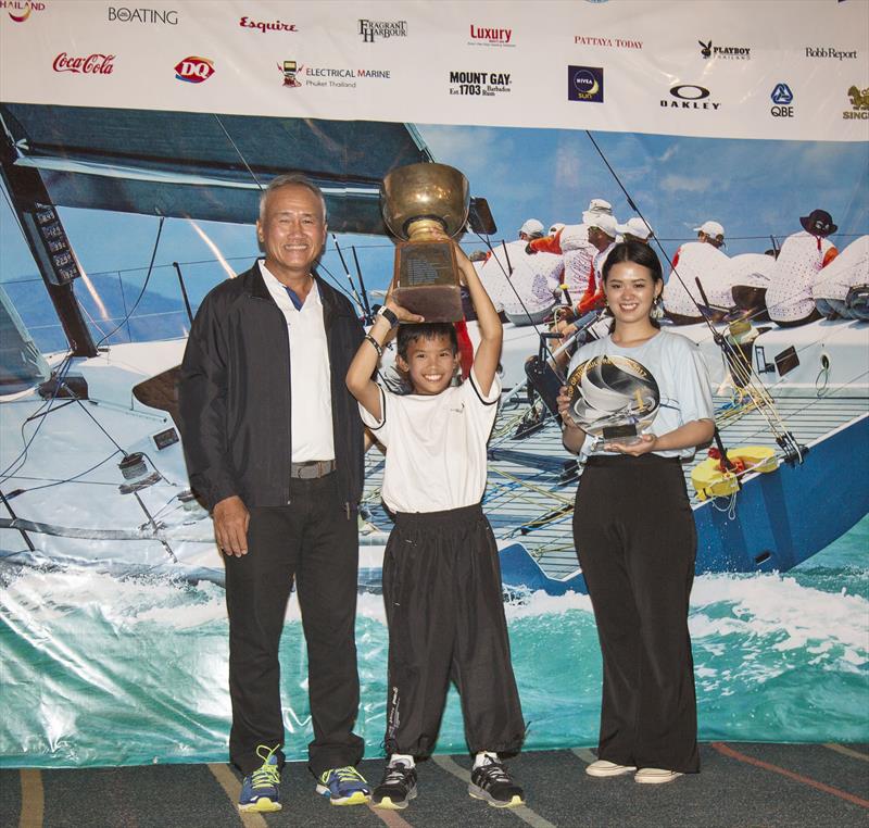 Panwa Boonnak lifting the trophy aloft, having been presented by Admiral Kraisorn Chansuvanich at the 2017 Top of the Gulf Regatta photo copyright Guy Nowell taken at Ocean Marina Yacht Club and featuring the Optimist class